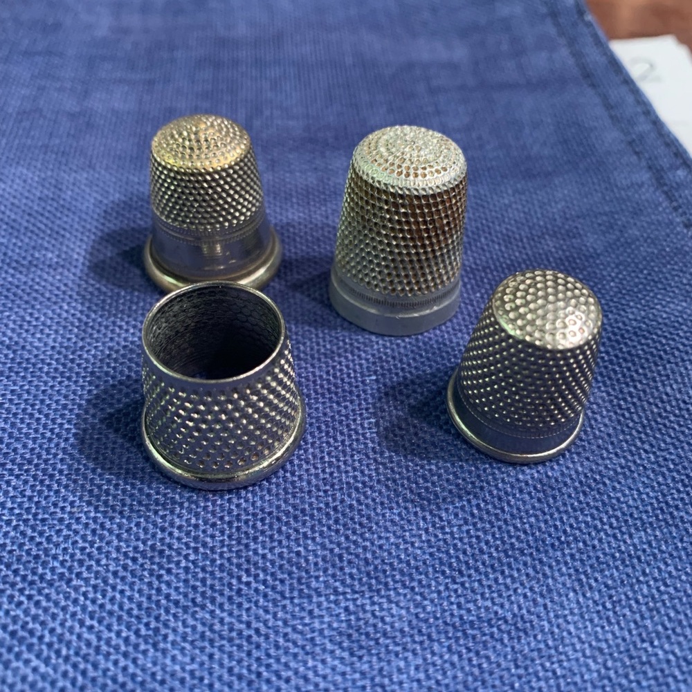4 antique thimbles.